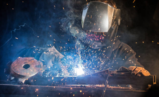 Welder working at the factory made metal