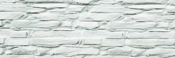 istock Stone wall background. White painted stone wall texture as background. Wood background wall painting. 911618016
