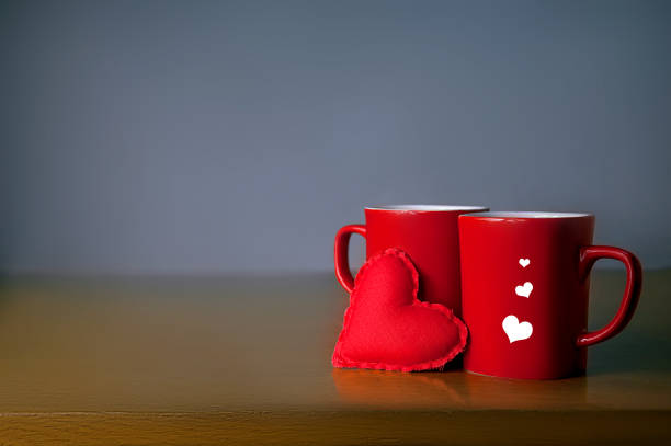istock Valentine's Day Concept. Two Red Cup with Soft Toy Heart on the Table on Grey Background 911618412