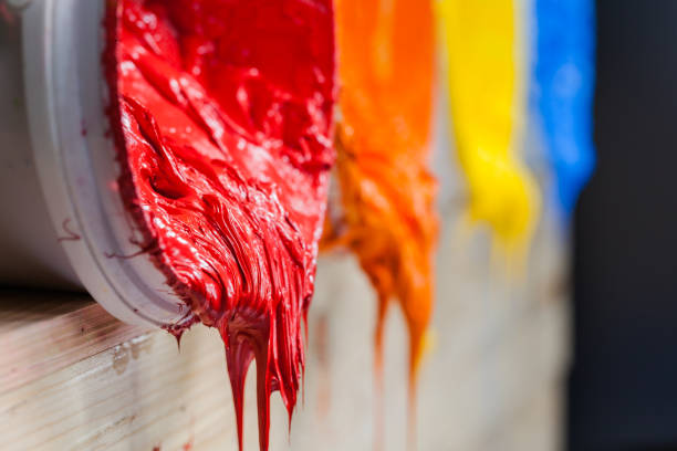 four colors of ink for print tee shirt flowed out of barrel red color of plastisol ink flowed out of the barrel. plastisol ink is specially for print on tee shirts and any fabric. the ink useful in tee shirt factory garment and industry for export hot mix plant stock pictures, royalty-free photos & images