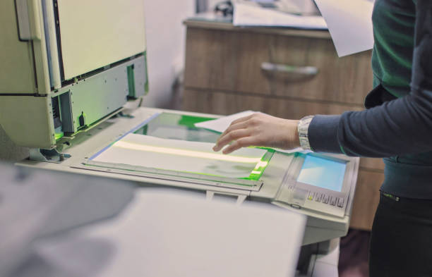 istock Woman making paper copies 911623306