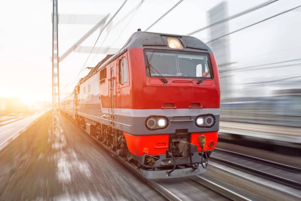 istock High-speed red passenger train rushing through the railway in the evening at sunset. 911633096