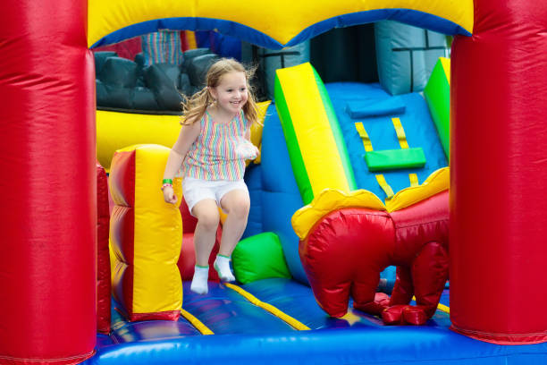 istock Child jumping on playground trampoline. Kids jump. 911649080
