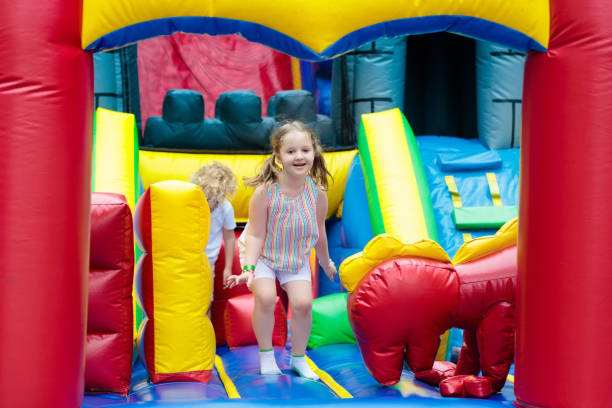 istock Child jumping on playground trampoline. Kids jump. 911649348