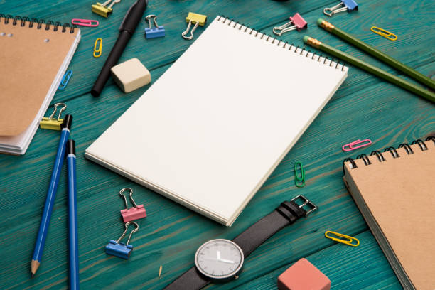 istock Workplace with notepad, glasses, watch and other office supply on a desk 911649614