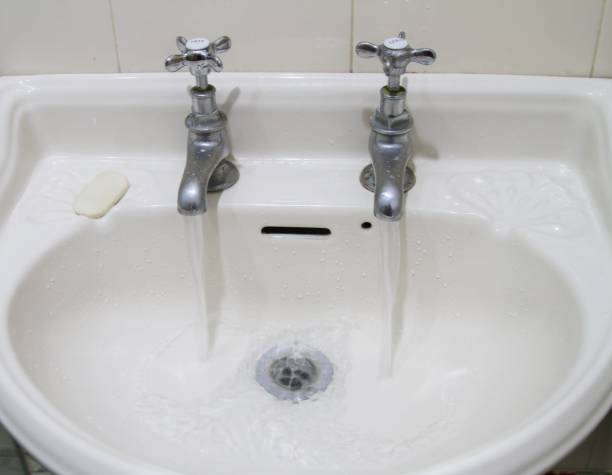istock old fashioned taps and sink with running water 911655556