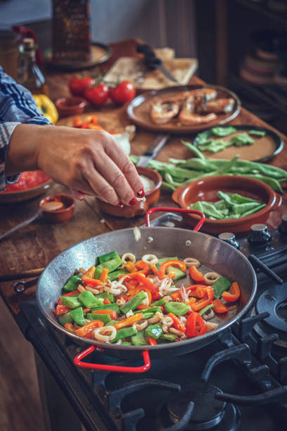 istock Preparing Seafood Paella with Shrimps and Calamari 911655800