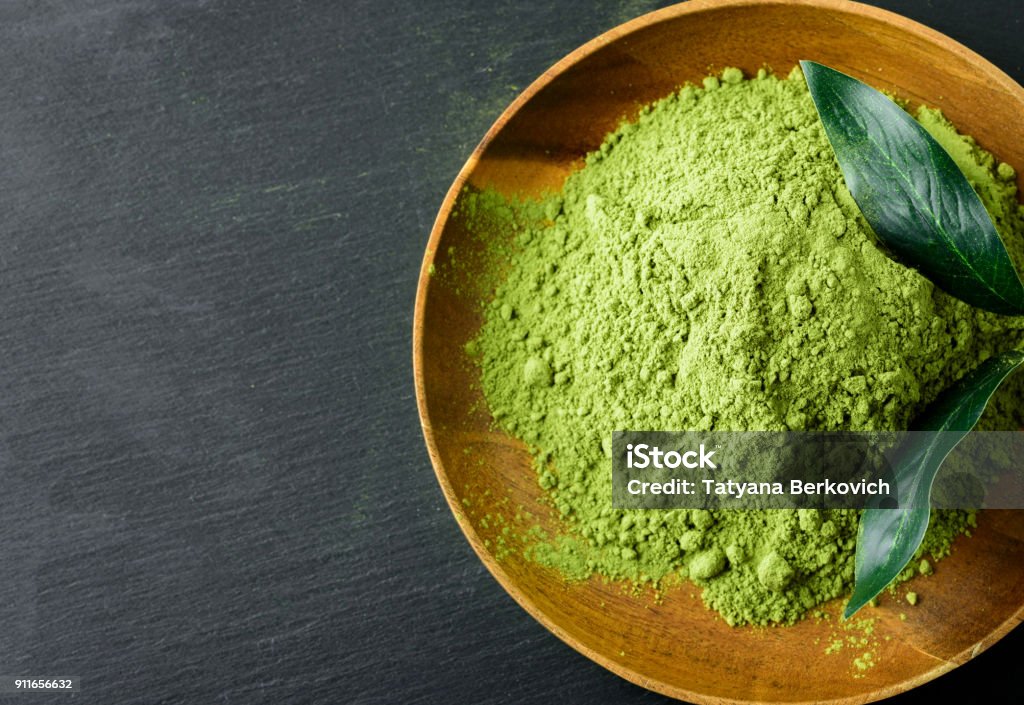 Japanese green tea matcha in a wooden bowl Ground - Culinary Stock Photo