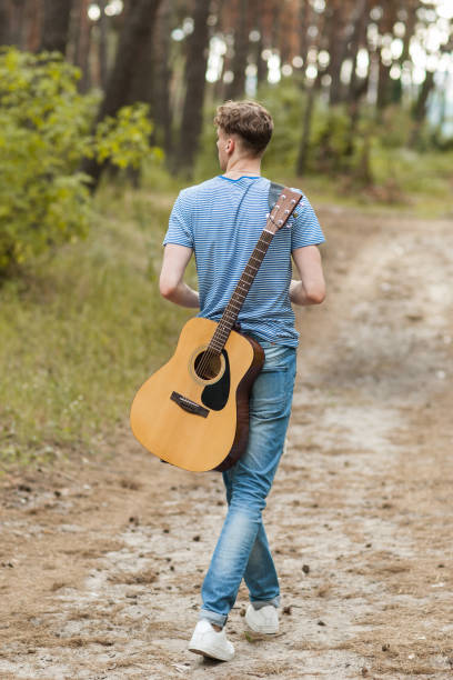 istock Talented guitarist playing forest hiking concept. 911661034