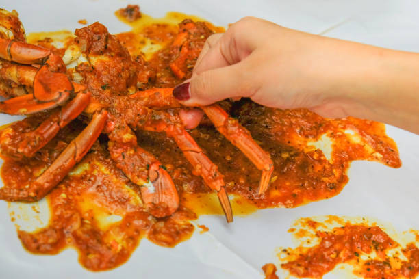 Women eating spicy chili crab