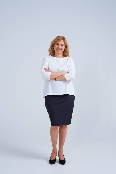 istock Smiley blond woman with folded arms 911668034