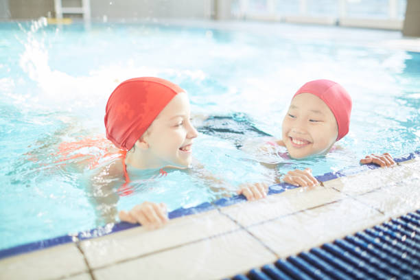istock Girls in swimming-pool 911668574