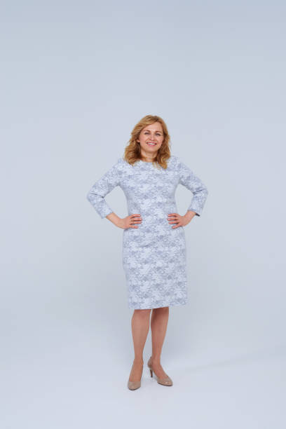 istock Mature blond in grey dress smiling 911671358