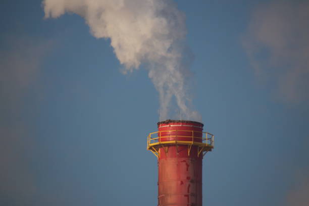 istock Smoked chimney on the refinary in sunset. 911675590