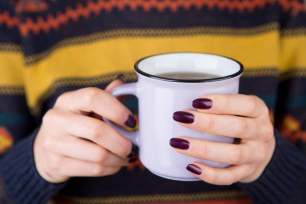 istock Woman in cozy sweater holding a cup 911675800