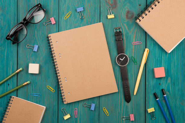 istock Workplace with notepad, glasses, watch and other office supply on a desk 911678300
