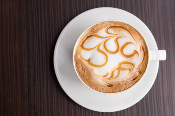 istock Hot latte art coffee cup on wooden table, Top view 911678670