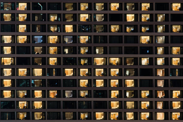 Lighting from many room are opened at night Lighting from many room are opened at night, pattern of room office window night stock pictures, royalty-free photos & images