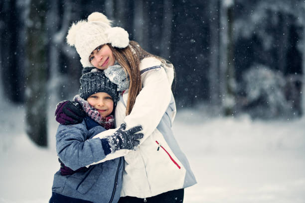 istock Brother and sister hugging on a winter day 911681248