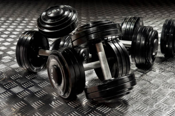 dumbbells with black discs weighting on the floor