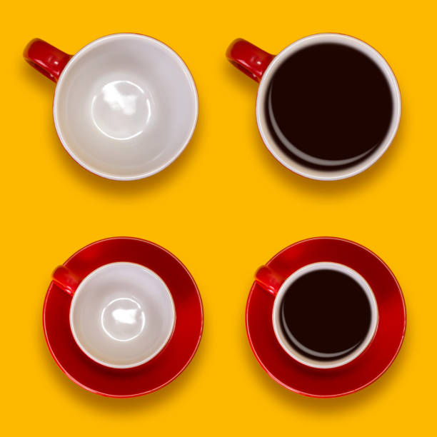 istock Set of empty and full red cups and a saucers. Coffee set on a yellow background 911684586