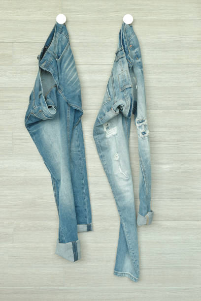 istock Jeans hanging on wooden wall 911690824