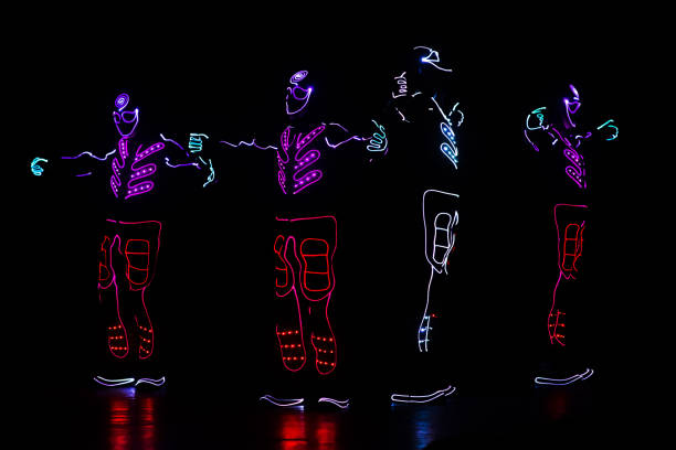 istock dancers in led suits on dark background, colored show 911691534