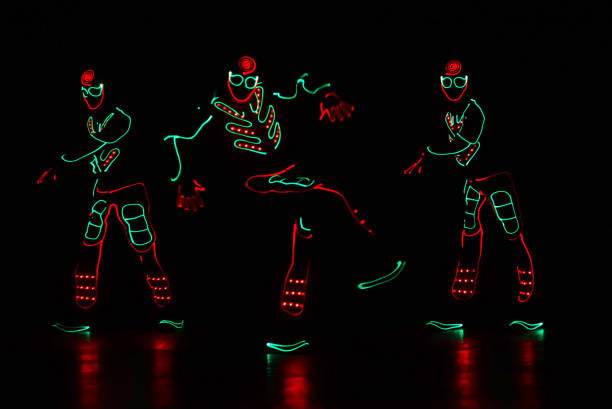 istock dancers in led suits on dark background, colored show 911691542
