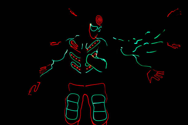 istock dancers in led suits on dark background, colored show 911691566