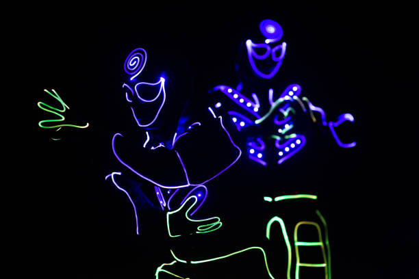 istock dancers in led suits on dark background, colored show 911691590