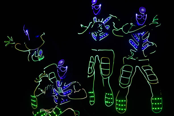 istock dancers in led suits on dark background, colored show 911691604
