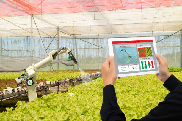 istock iot smart industry robot 4.0 agriculture concept,industrial agronomist,farmer using software Artificial intelligence technology in tablet to monitoring condition and control automatic robotics in farm 911693790