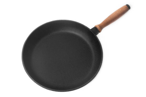 istock cast-iron frying pan on a white background 911694560