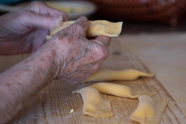 istock Hands of old woman preparing ravioli 911698764