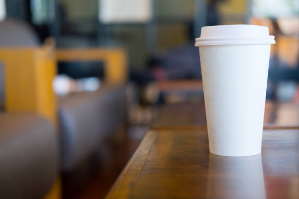 istock Single hot latte Single hot latte in paper cup on wood table 911699852