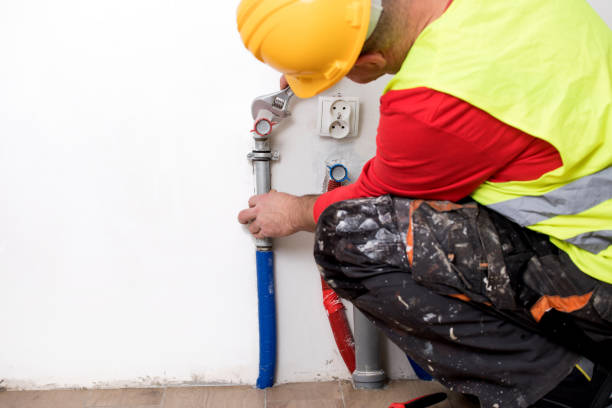 istock Hands of Plumber with a wrench 911700018