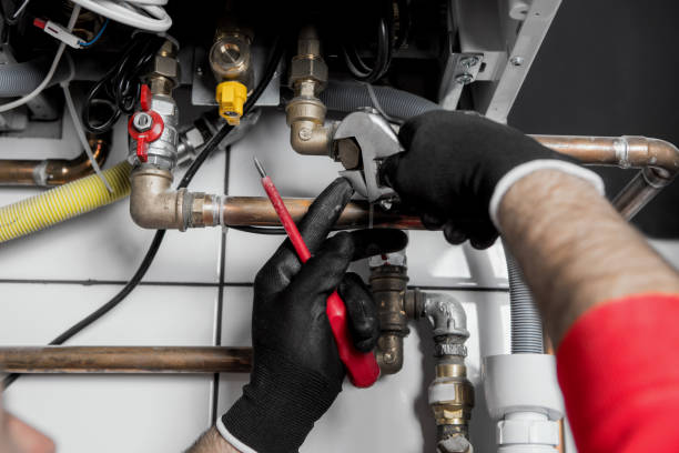 istock Hands of Plumber with a wrench 911702774