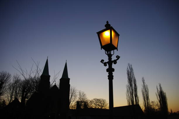 Church towers in respective with nostalgic streetlight in the foreground