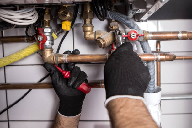 istock Hands of Plumber with a wrench 911703350