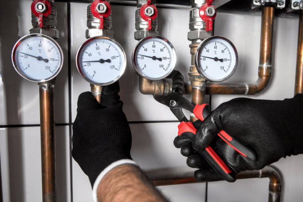 istock Hands of Plumber with a wrench 911706766