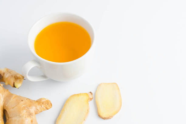istock hot ginger tea ginger ale ginger beer in glass with ginger slice on white background 911708912