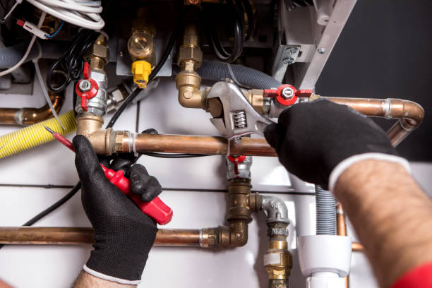 istock Hands of Plumber with a wrench 911709510