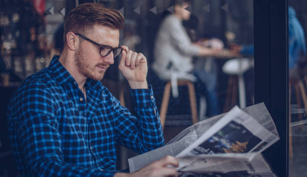 istock Man reading newspaper in cafe 911712478