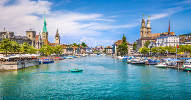 ZÃ¼rich city center with river Limmat, Switzerland Panoramic view of historic Zurich city center with famous Fraumunster, Grossmunster and St. Peter and river Limmat at Lake Zurich on a sunny day with clouds in summer, Canton of Zurich, Switzerland zurich photos stock pictures, royalty-free photos & images
