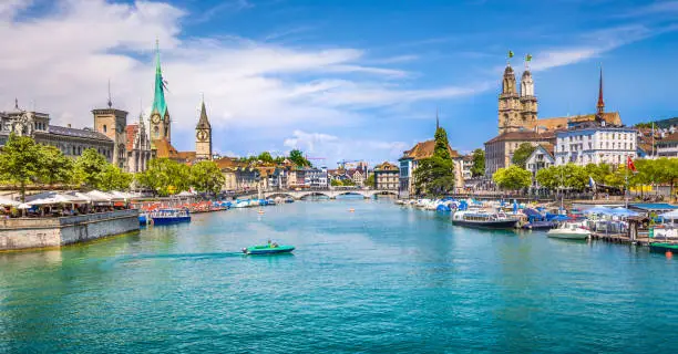 Panoramic view of historic Zurich city center with famous Fraumunster, Grossmunster and St. Peter and river Limmat at Lake Zurich on a sunny day with clouds in summer, Canton of Zurich, Switzerland