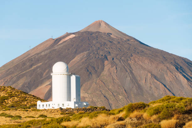 istock Solar observatory in the mountains with volcano in background 911717054