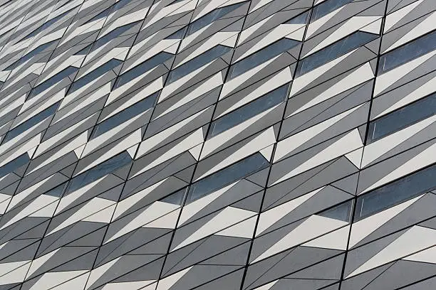 Patterned wall of a modern building made of metal and glass.