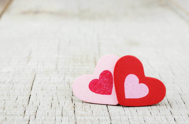 istock hearts on wooden background. 911724024