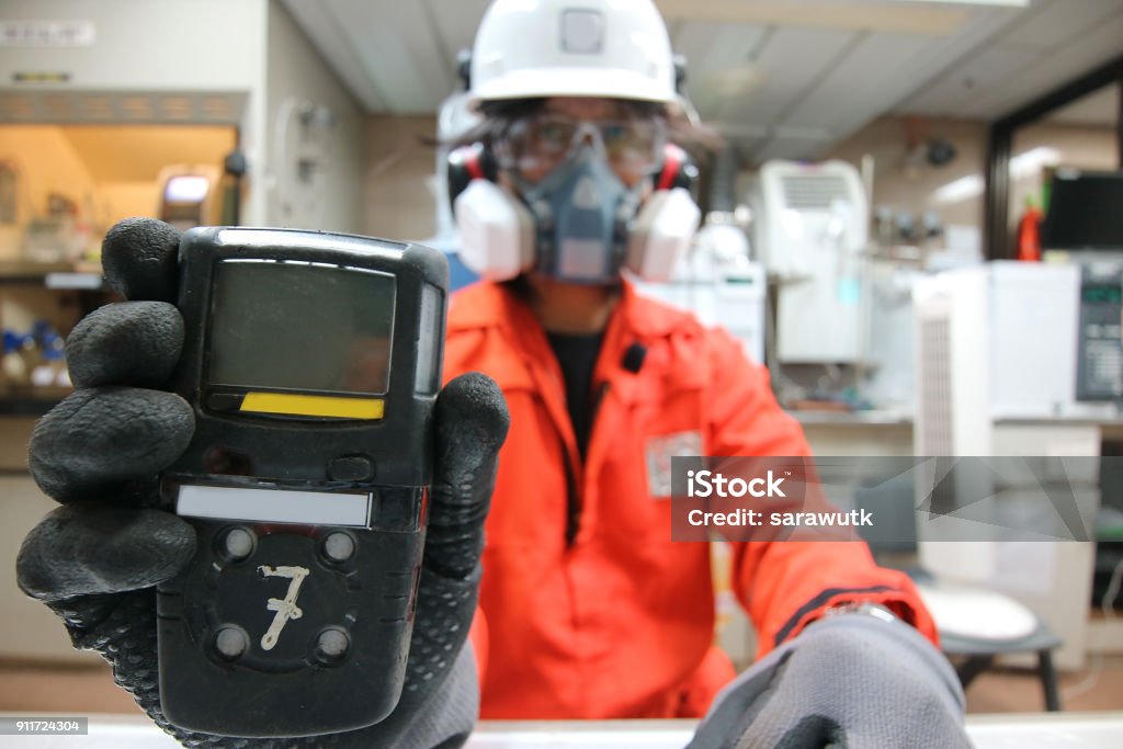 Instrument technician is take standard gas for the job calibrate or function check of personal gas tester or gas detector. Gas Stock Photo