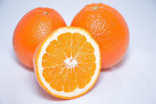 Close-up view of fresh oranges isolated on white background